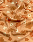 (FRENCH TERRY) RUST, BURNT ORANGE AND OFF WHITE DAISIES ON LIGHT ORANGE