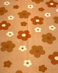(FRENCH TERRY) RUST, BURNT ORANGE AND OFF WHITE DAISIES ON LIGHT ORANGE