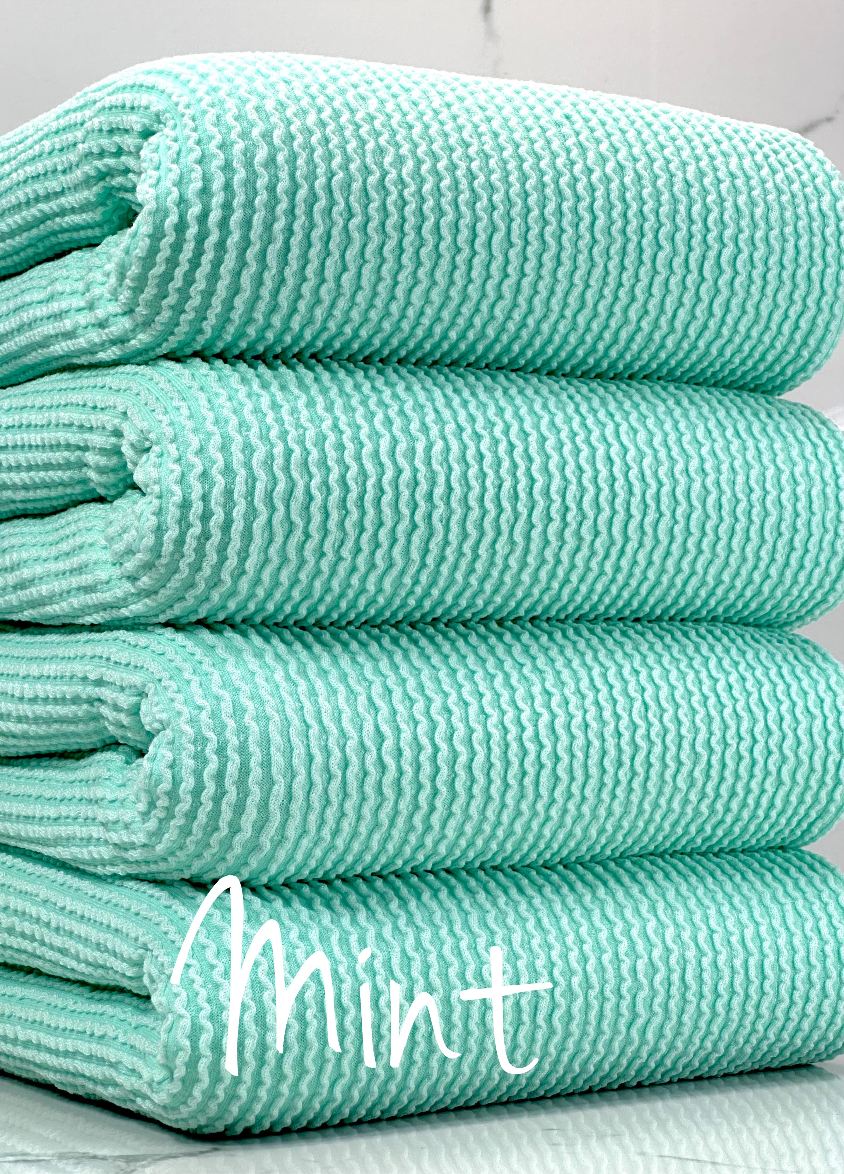 Light green, blue, mint show texture of ribbed cotton fabric wave