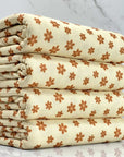 (THERMAL) TINY BURNT ORANGE FLOWERS ON CREAM