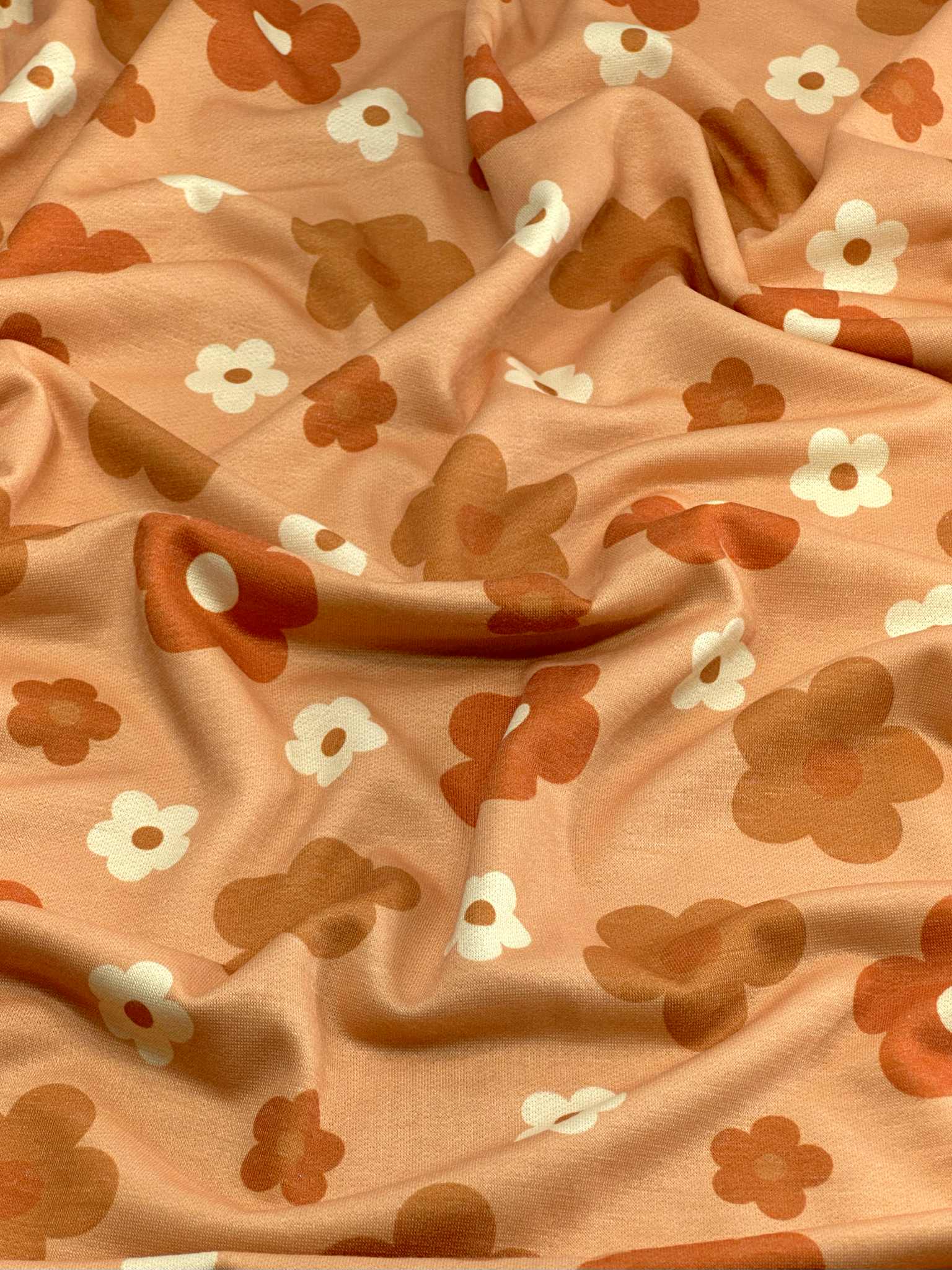 (FRENCH TERRY) RUST, BURNT ORANGE AND OFF WHITE DAISIES ON LIGHT ORANGE (1)