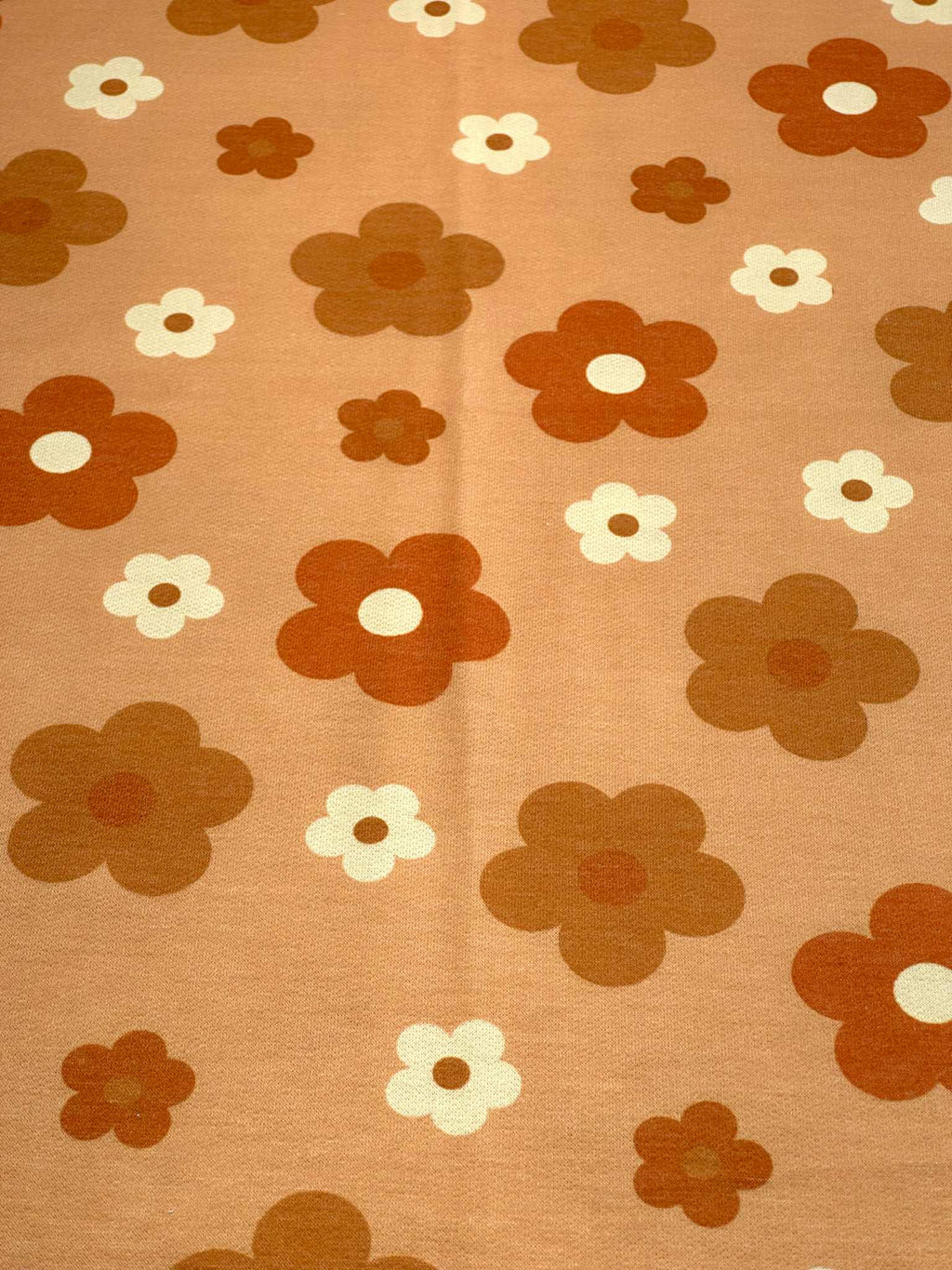 (FRENCH TERRY) RUST, BURNT ORANGE AND OFF WHITE DAISIES ON LIGHT ORANGE (1)