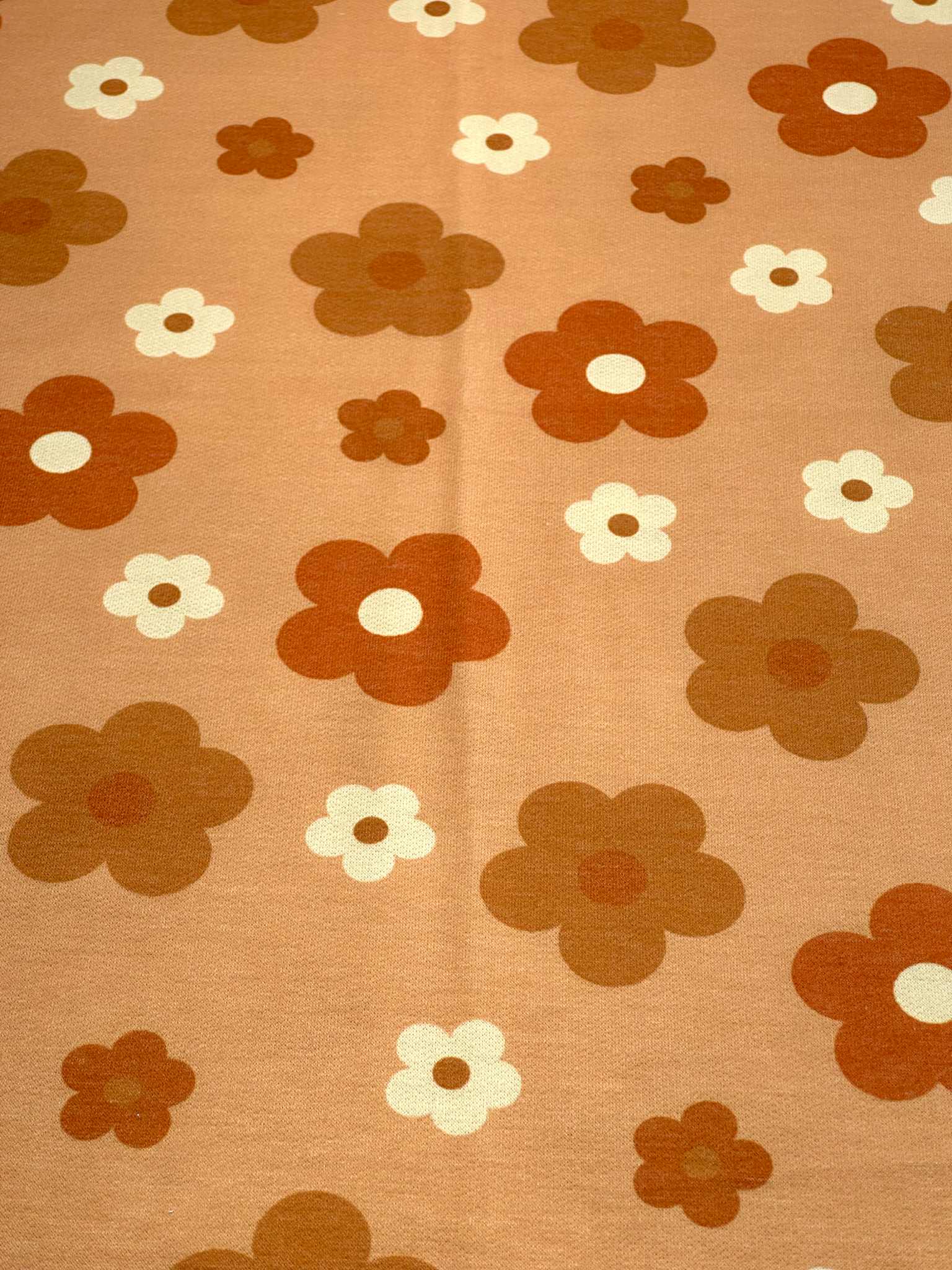 (FRENCH TERRY) RUST, BURNT ORANGE AND OFF WHITE DAISIES ON LIGHT ORANGE (1)
