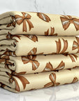 (DBP) FOOTBALL BOWS ON TAN