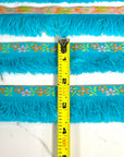 (TRIM) KNIT FLOWER BORDER ON BLUE BRUSH FRINGE