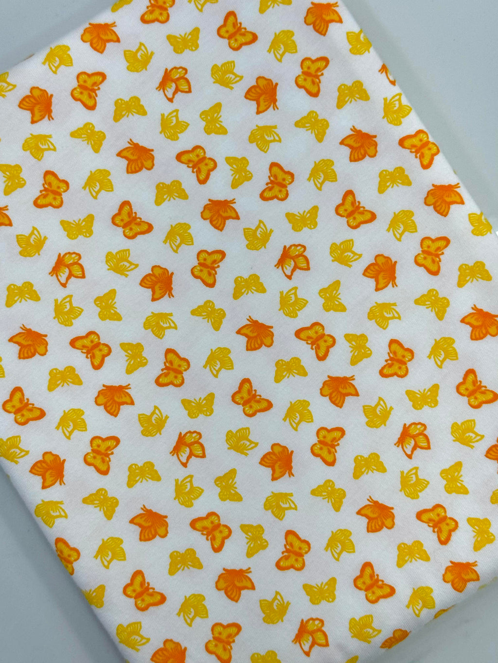 (COTTON SPANDEX) SMALL YELLOW AND ORANGE BUTTERFLIES ON OFF WHITE