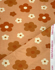 (FRENCH TERRY) RUST, BURNT ORANGE AND OFF WHITE DAISIES ON LIGHT ORANGE