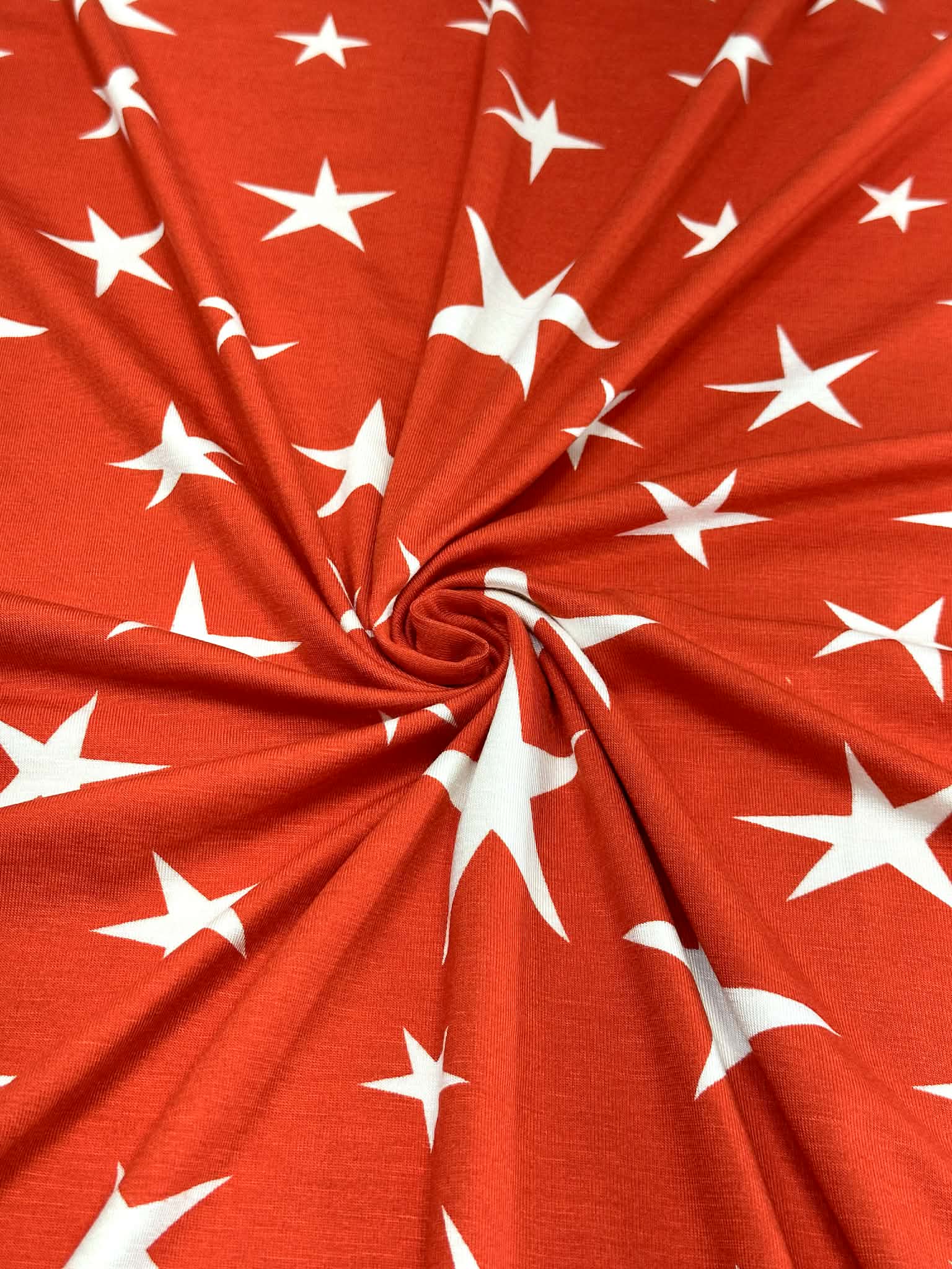 (RAYON  MODAL) OFF WHITE STARS ON RED