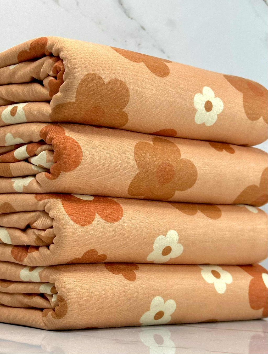 (FRENCH TERRY) RUST, BURNT ORANGE AND OFF WHITE DAISIES ON LIGHT ORANGE (1)