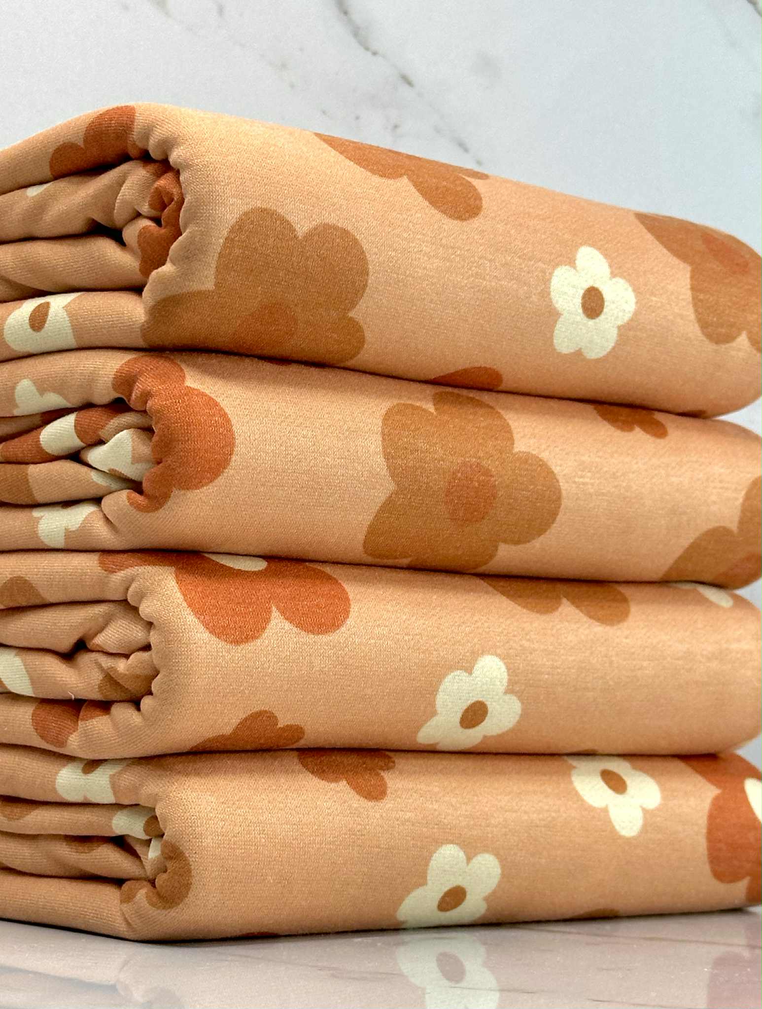 (FRENCH TERRY) RUST, BURNT ORANGE AND OFF WHITE DAISIES ON LIGHT ORANGE (1)