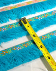 (TRIM) KNIT FLOWER BORDER ON BLUE BRUSH FRINGE