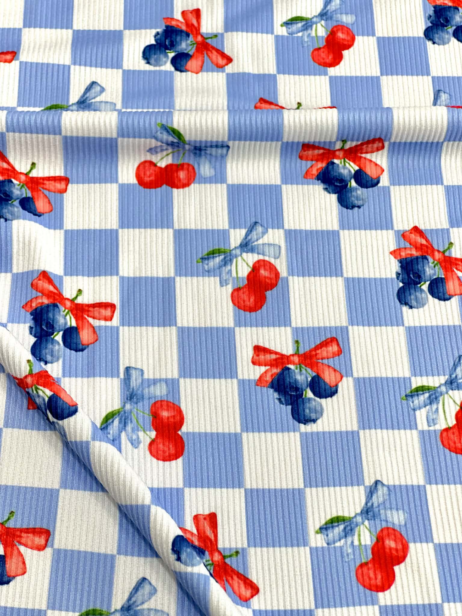 (2X2 YUMMY RIB) CHERRIES AND BLUEBERRIES WITH BOWS ON BLUE AND OFF WHITE CHECKERED