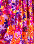 (ITY) PURPLE FLOWERS ON ORANGE