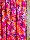 (ITY) PURPLE FLOWERS ON ORANGE