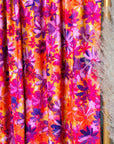 (ITY) PURPLE FLOWERS ON ORANGE