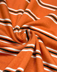 (RAYON MODAL) BLACK AND OFF WHITE STRIPES ON DARK ORANGE