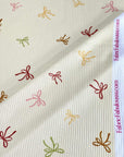 (4X2 RIB) LIGHT MUSTARD, BROWN, PINK AND GREEN BOWS ON CREAM