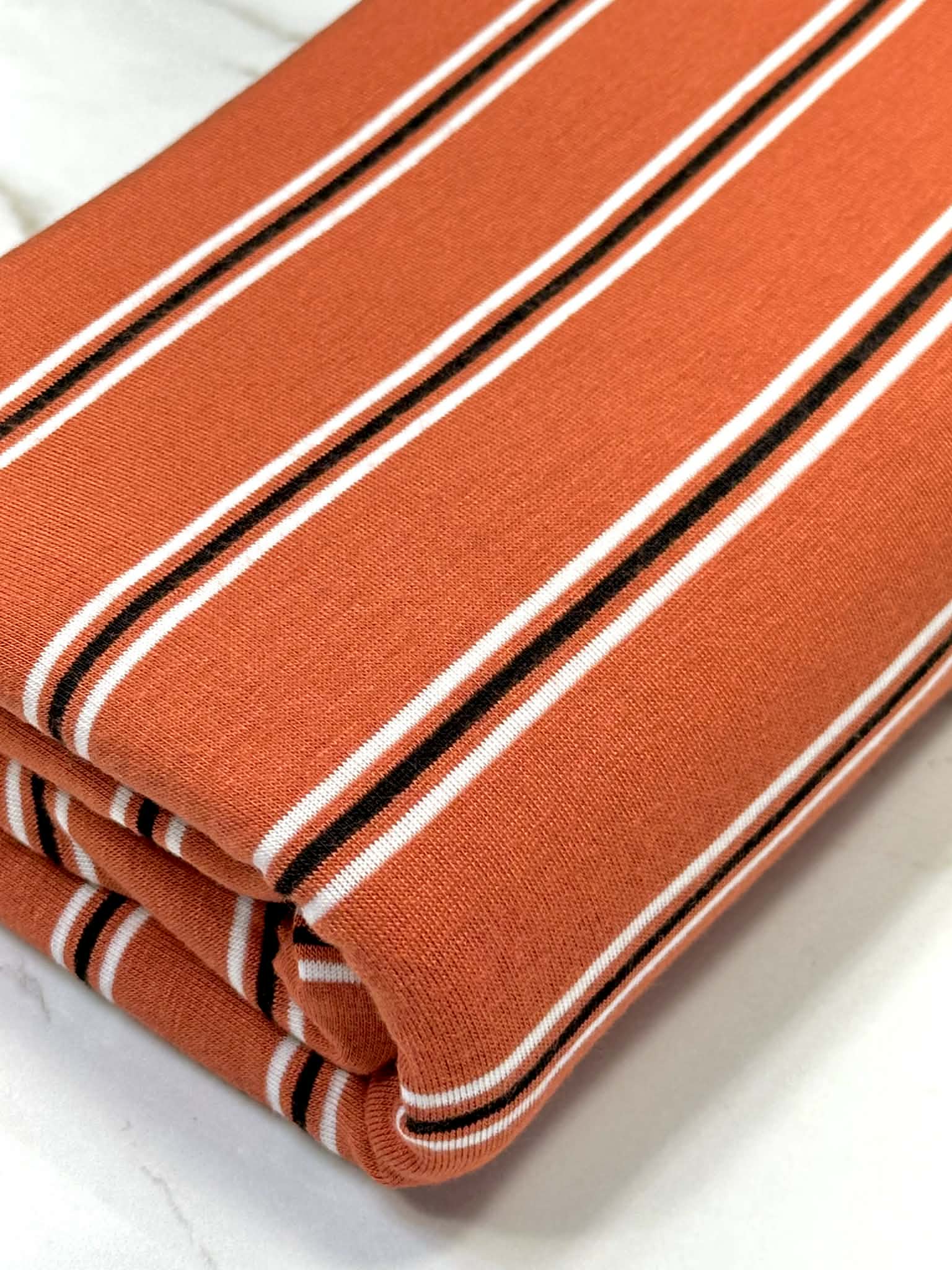 (RAYON MODAL) BLACK AND OFF WHITE STRIPES ON DARK ORANGE (3)