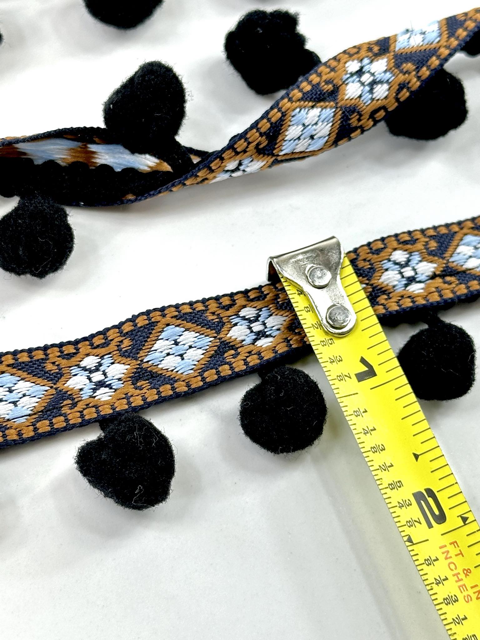 (TRIM) NAVY AND BLUE AZTEC PATTERN WITH BLACK POM POM BALL