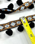 (TRIM) NAVY AND BLUE AZTEC PATTERN WITH BLACK POM POM BALL