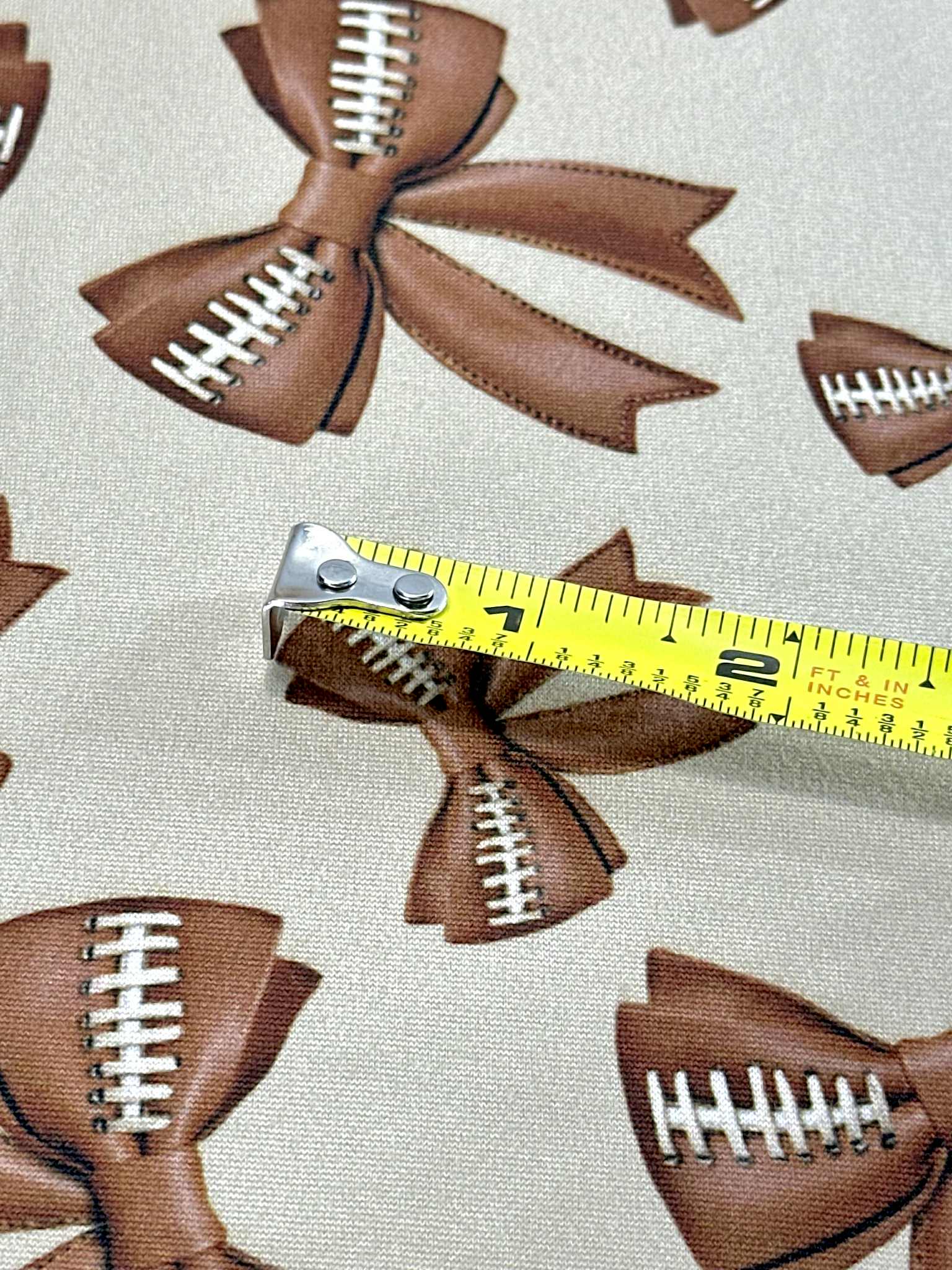 (DBP) FOOTBALL BOWS ON TAN