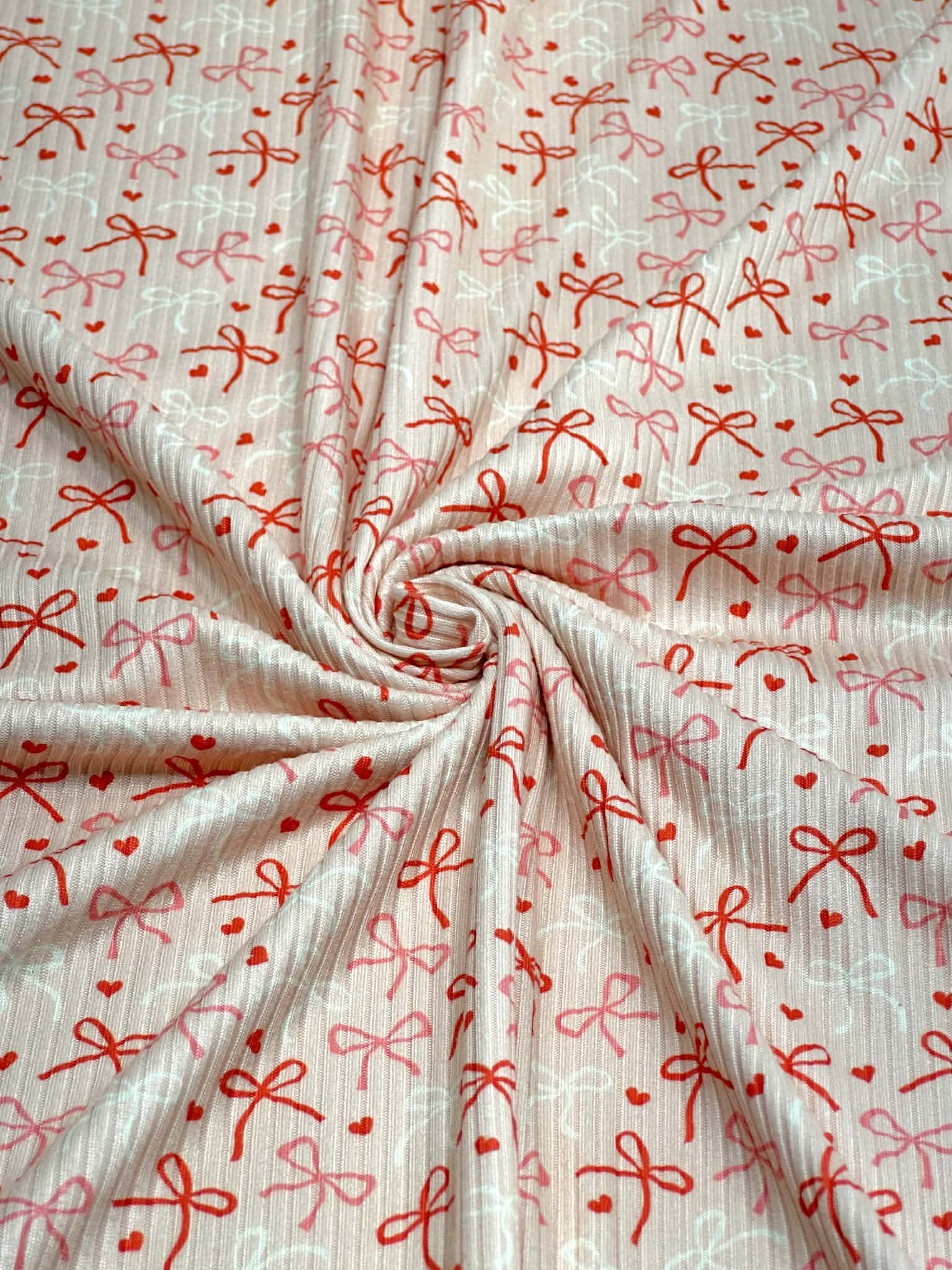 (4X2 YUMMY RIB) RED, PINK, AND IVORY BOWS WITH TINY HEARTS ON LIGHT BLUSH (3)