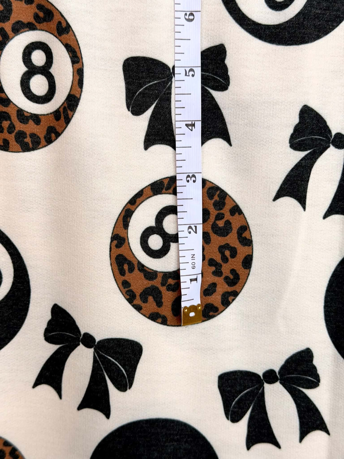 (FRENCH TERRY) BLACK BOW  AND LEOPARD 8-BALL PRINT ON CREAM