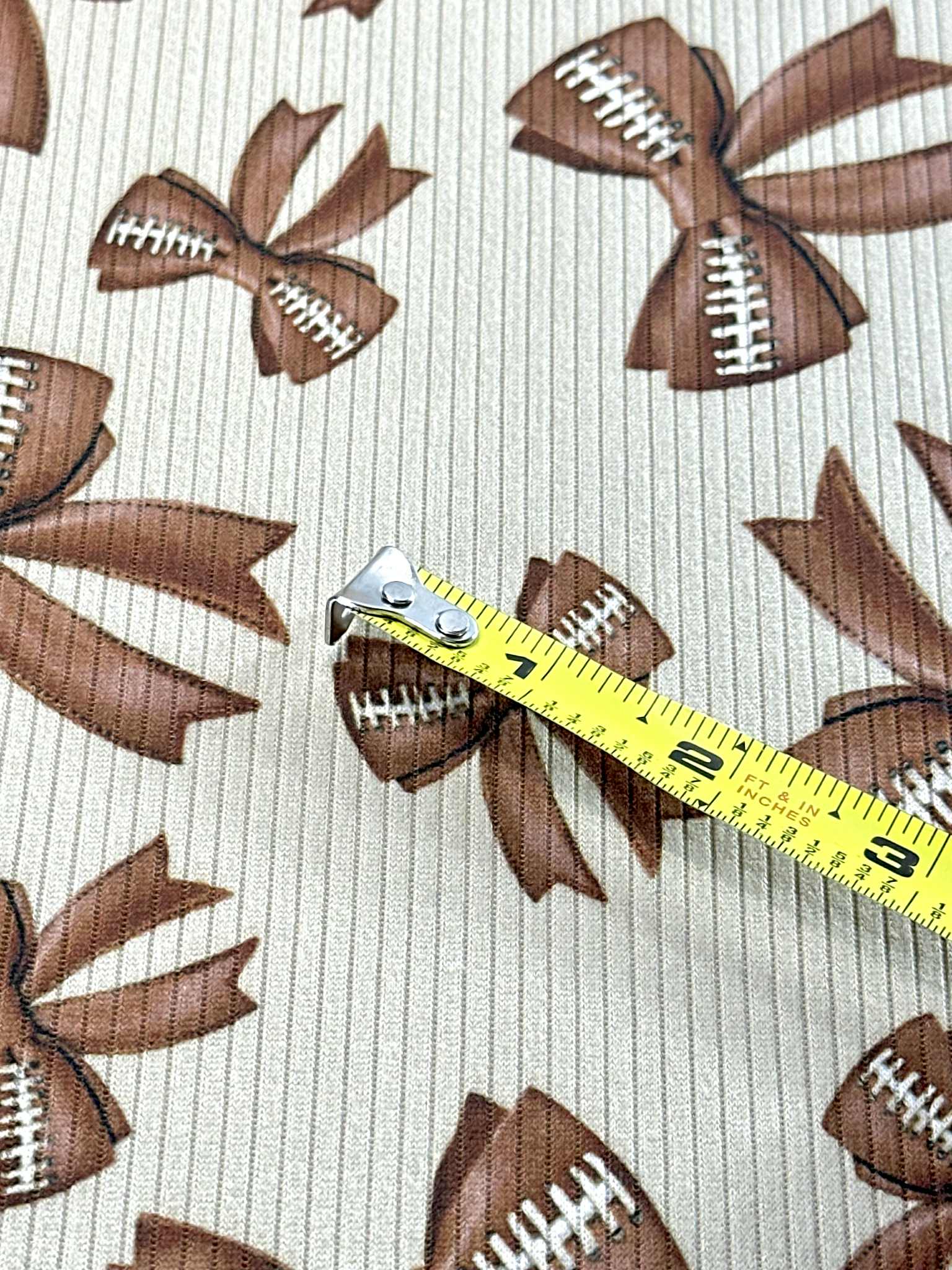 (4X2 RIB) FOOTBALL BOWS ON TAN