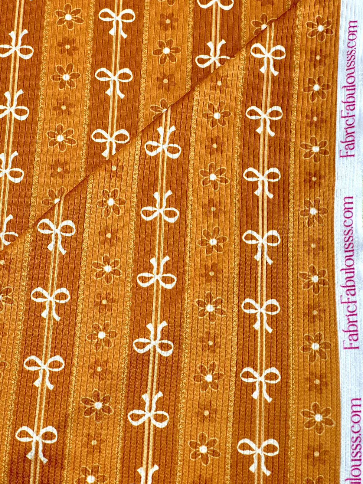 (4X2 RIB) FLOWER AND OFF WHITE BOWS PATTERN ON APRICOT