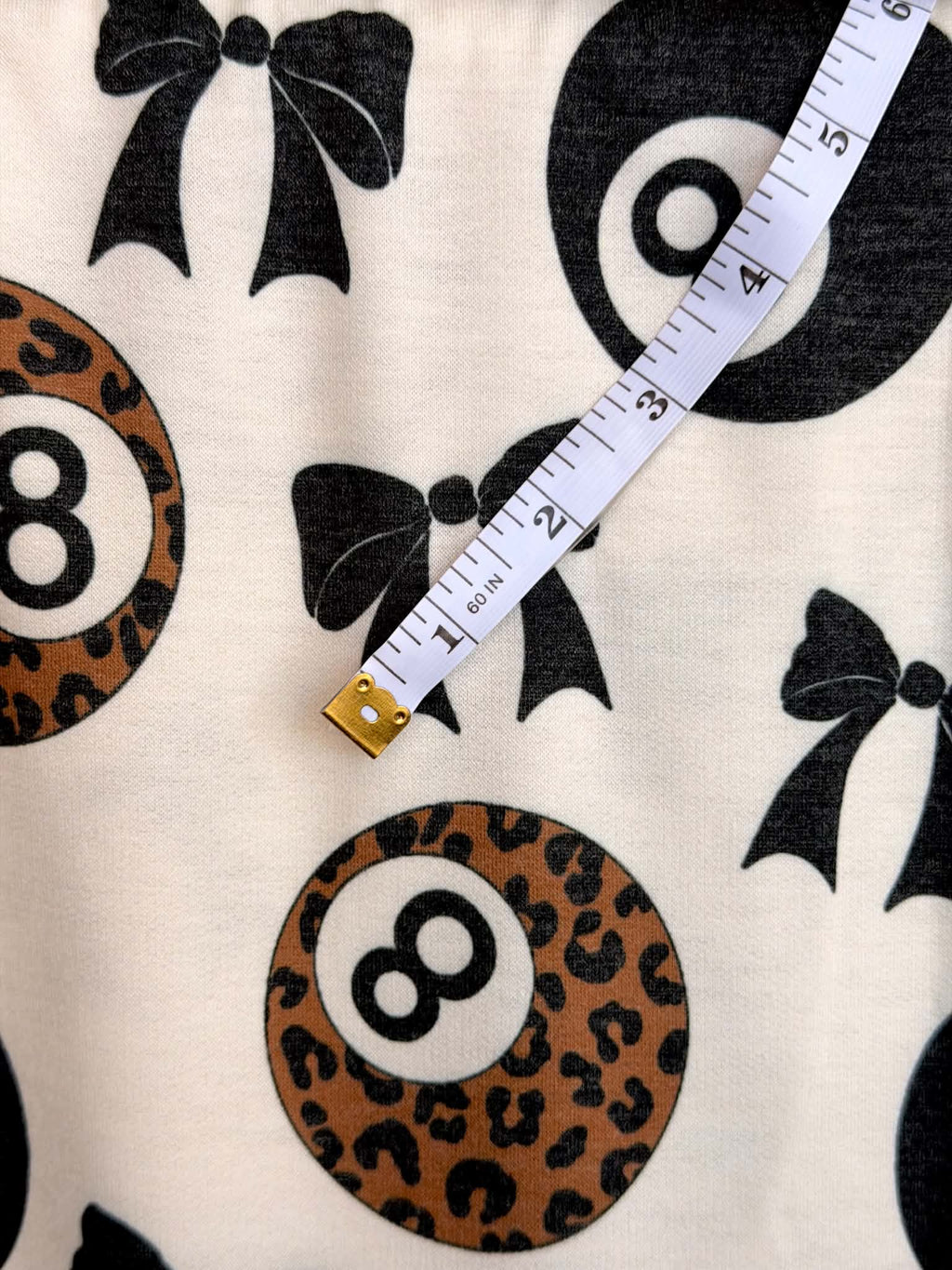 (FRENCH TERRY) BLACK BOW  AND LEOPARD 8-BALL PRINT ON CREAM