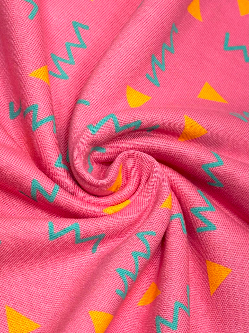 (HEAVY FRENCH TERRY) ORANGE TRIANGLES AND TURQUOISE SQUIGGLY ON PINK (1)