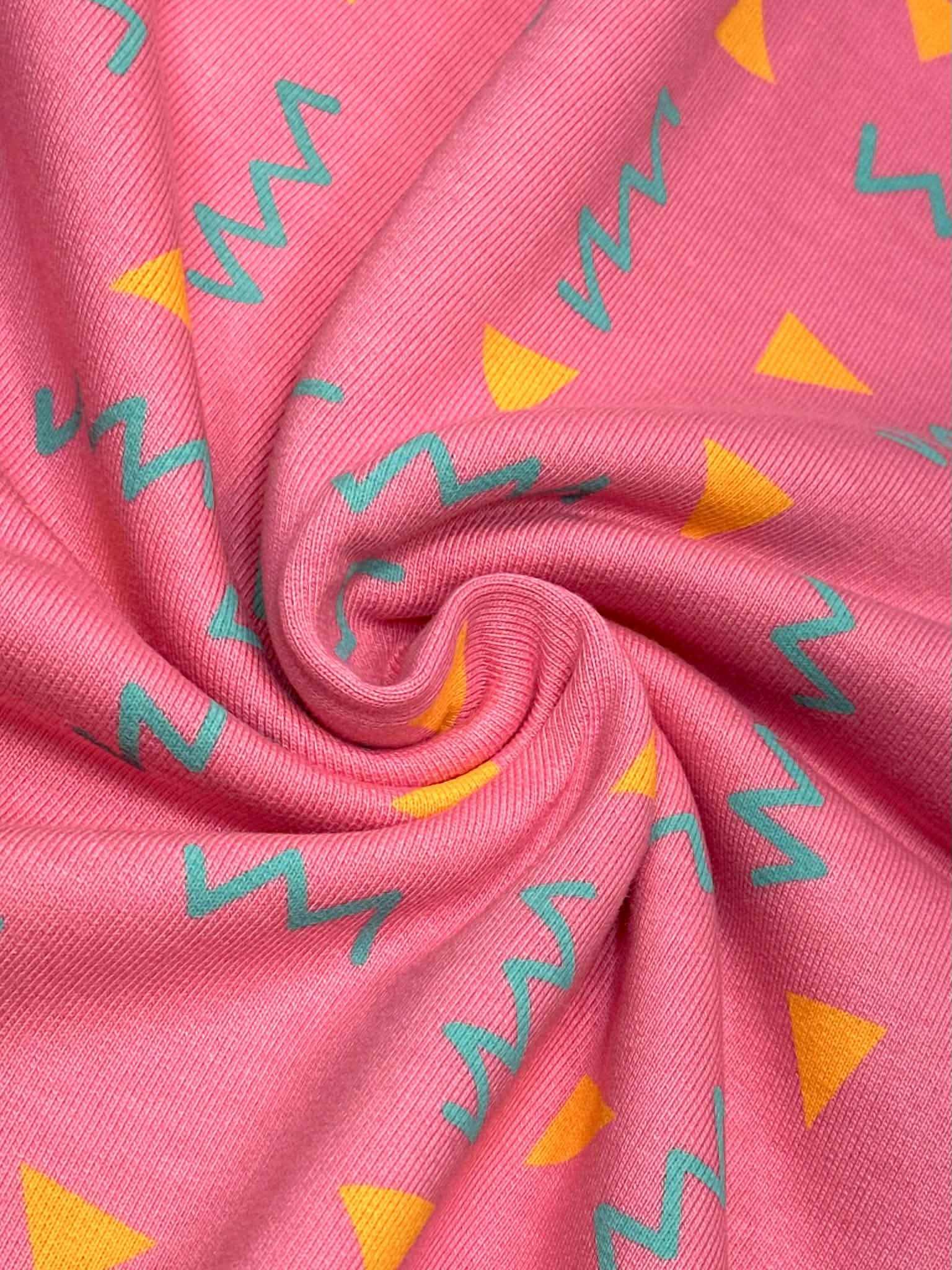 (HEAVY FRENCH TERRY) ORANGE TRIANGLES AND TURQUOISE SQUIGGLY ON PINK (1)