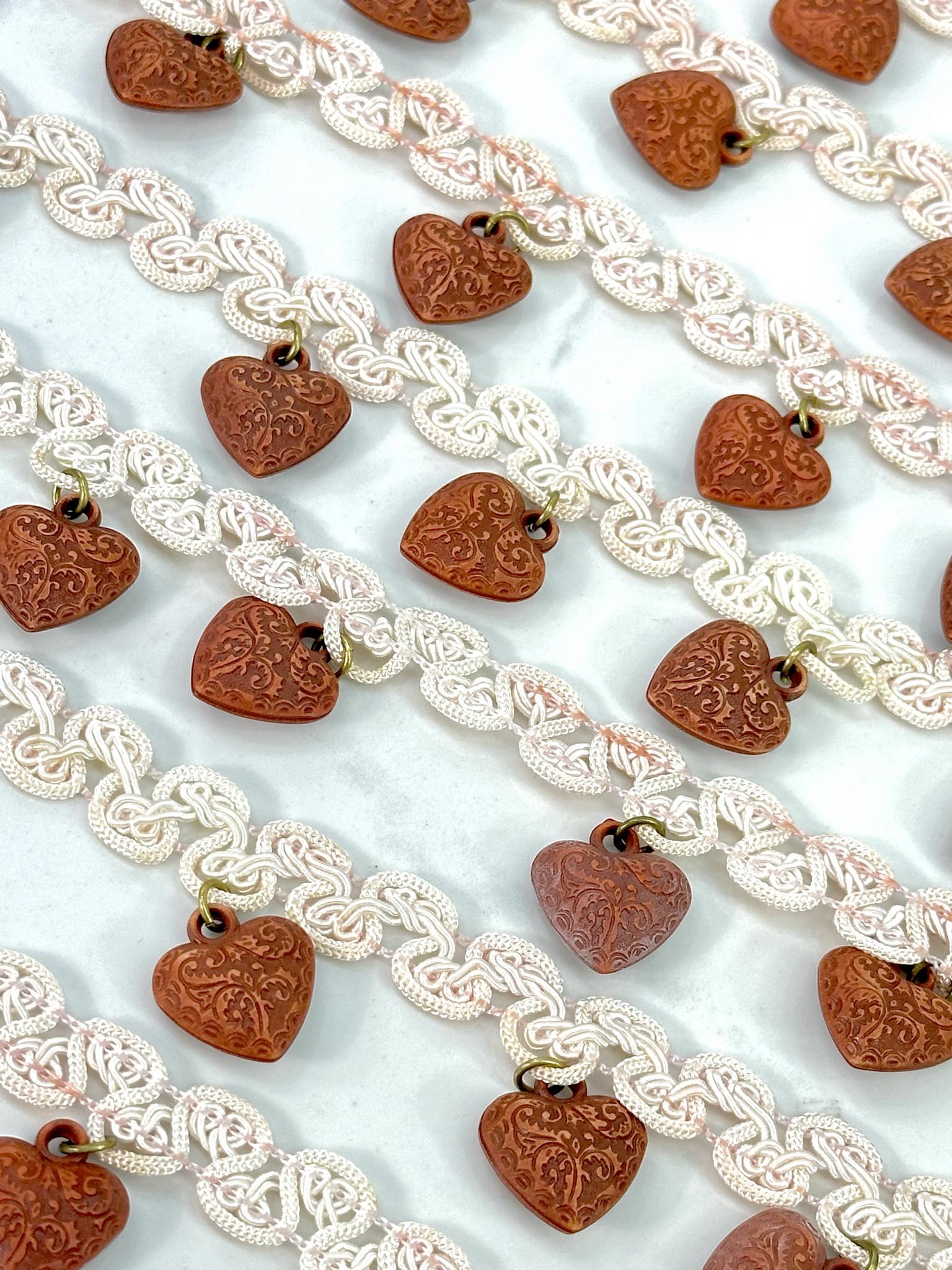 (TRIM) IVORY STRIP WITH VINTAGE HEART CHARMS